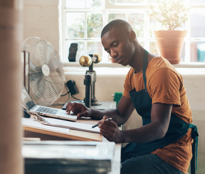 Male African American entrepreneur working in home office on writing their executive summary.